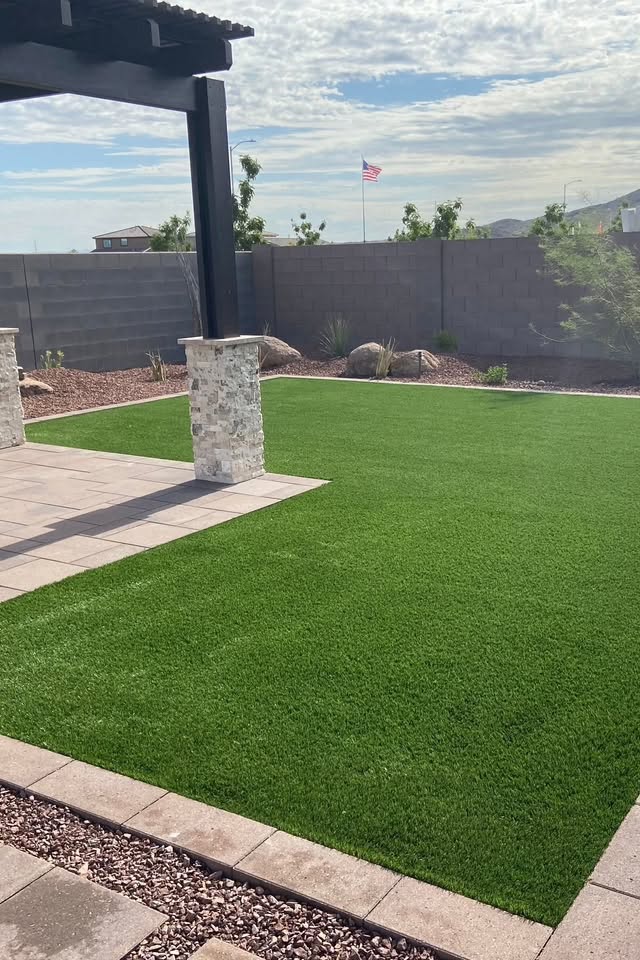 Artificial turf installation with stone pergola