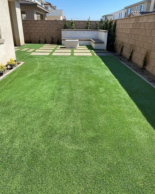 Backyard turf installation with seating area